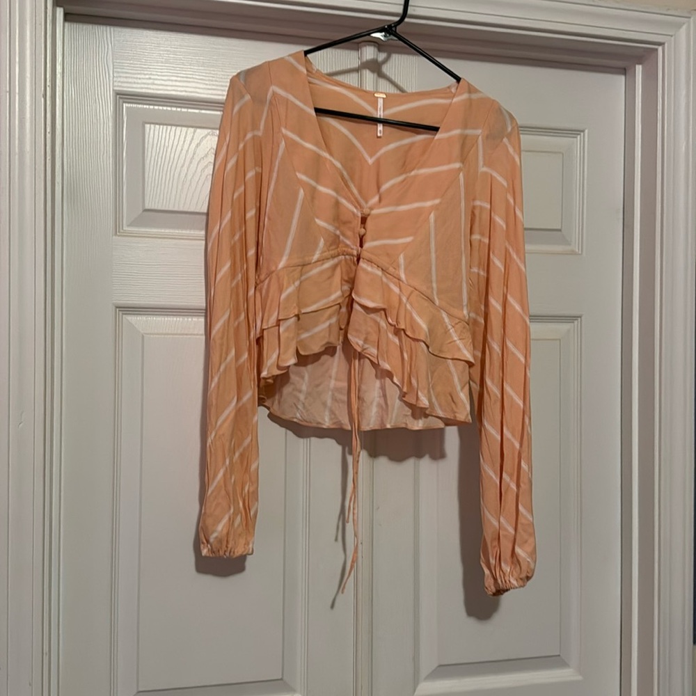Cute free people crop top, the color is a more muted coral in person